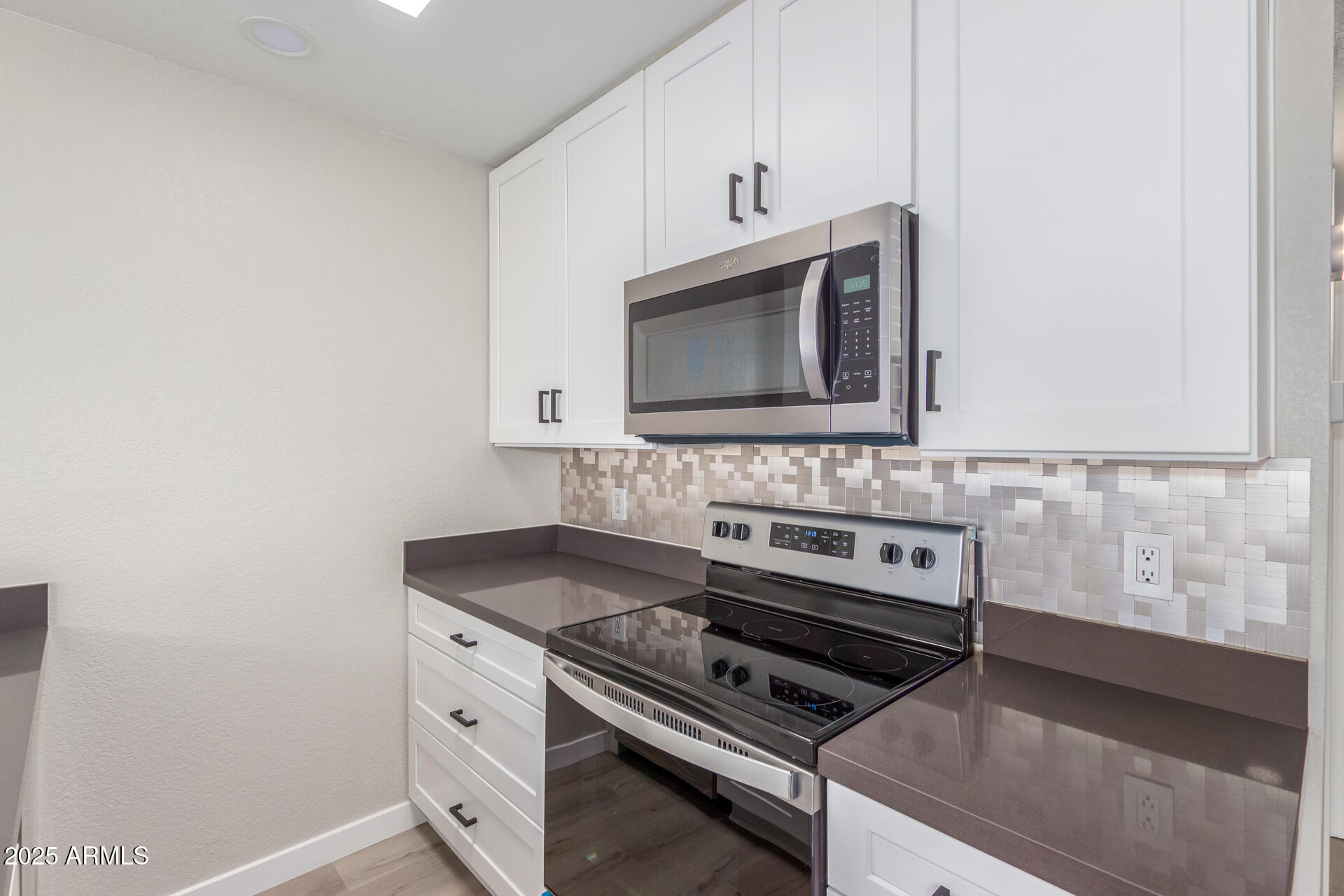 8888 North 47th Avenue, Unit 212 Glendale, AZ 85302 - Photo 7 of 18 a kitchen with a stove microwave and sink