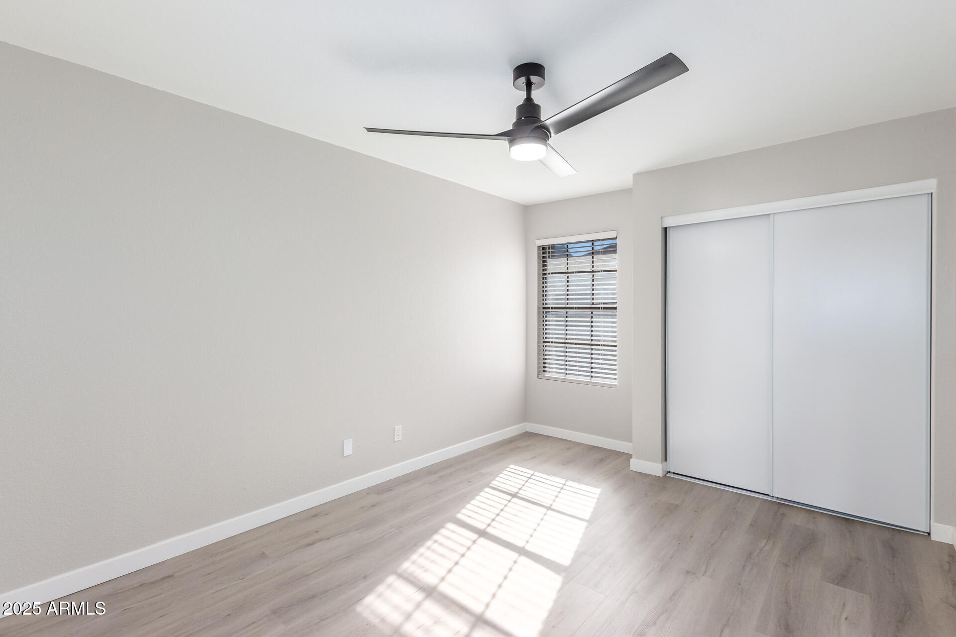 8888 North 47th Avenue, Unit 212 Glendale, AZ 85302 - Photo 10 of 18 wooden floor in an empty room with a window