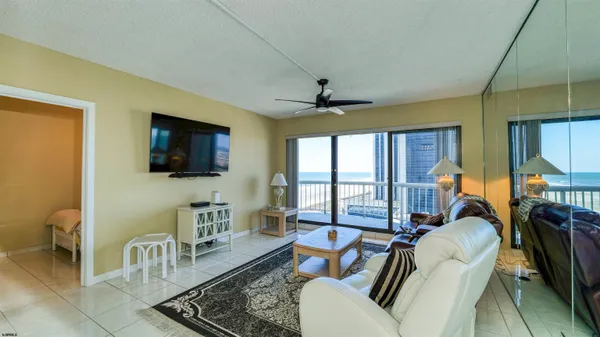 a living room with furniture a flat screen tv and a couch