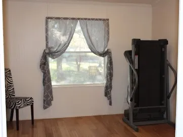 a view of walk in closet with window and a potted plant on a table