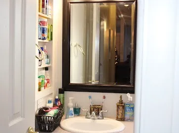 a bathroom with a sink a mirror and a shower curtain