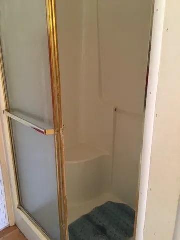 a bathroom with a glass door shower