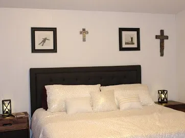 a bedroom with a bed and wall painting