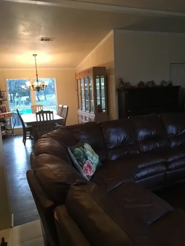 a living room with furniture and a lamp