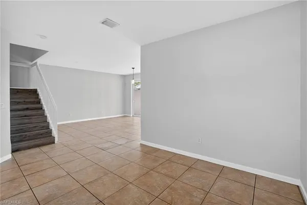 a view of an empty room with stairs