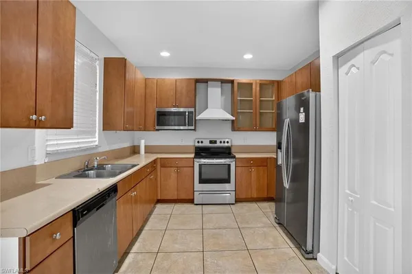 a kitchen with a sink a refrigerator and cabinets
