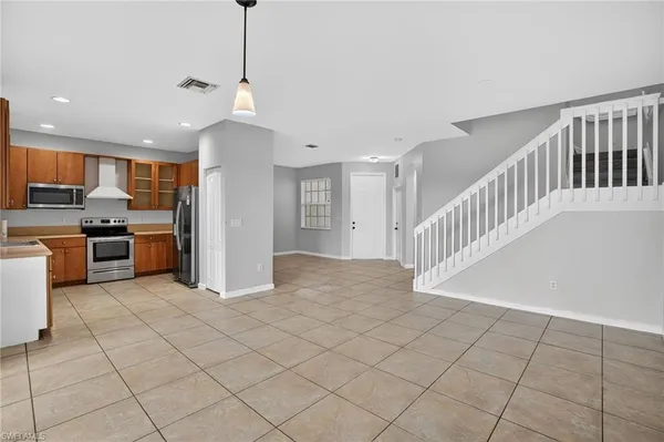 a view of a kitchen with cabinets and stainless steel appliances