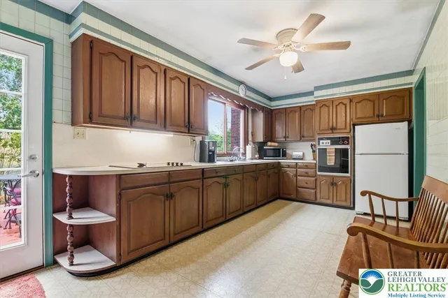 a kitchen with stainless steel appliances granite countertop a refrigerator sink and cabinets