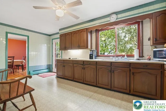 a kitchen with granite countertop a window cabinets stainless steel appliances and a counter space