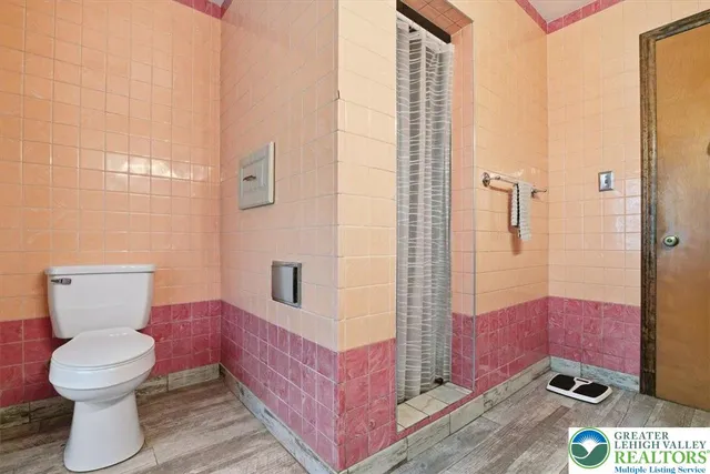 a bathroom with a toilet a sink and mirror