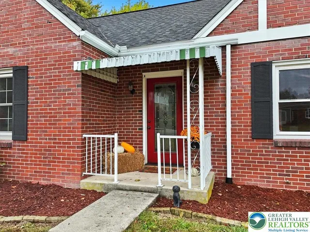 a view of brick house with large windows