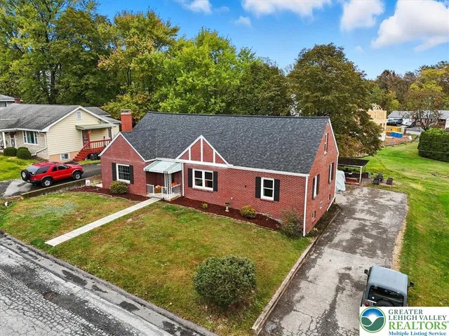 an aerial view of a house with a yard