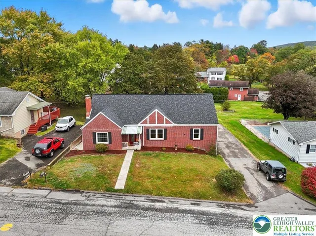 a front view of a house with a yard table and chairs