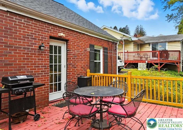 a backyard of a house with yard barbeque oven and outdoor seating