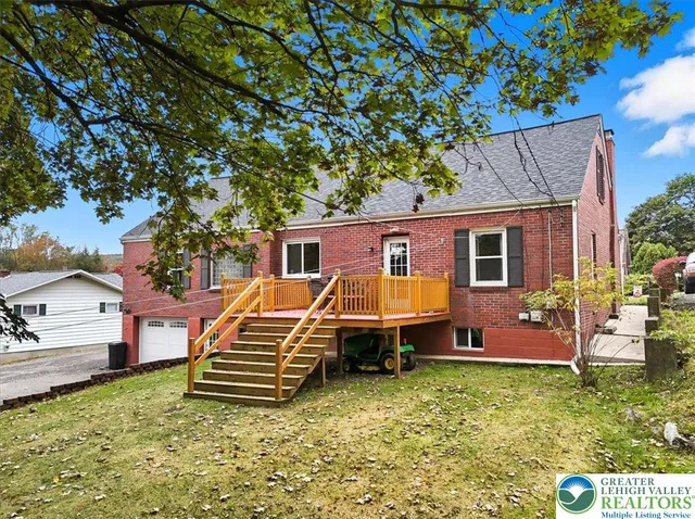 a view of a patio with couches table and chairs and potted plants