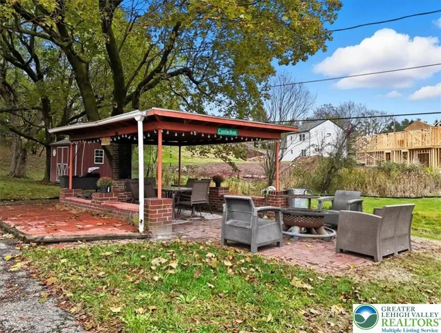an aerial view of a tennis ground and a large tree