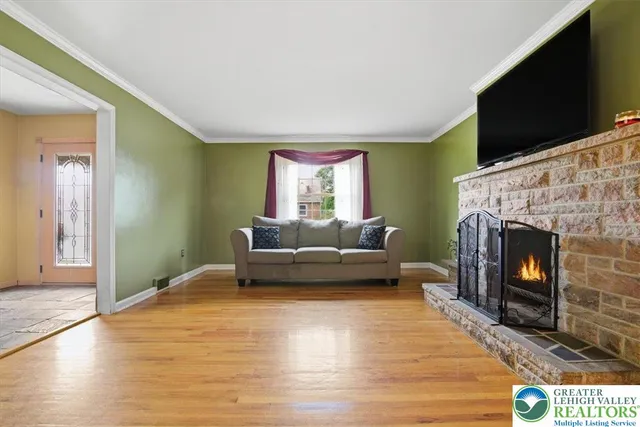 a living room with furniture a flat screen tv and a fireplace