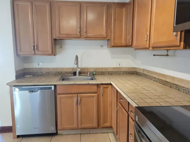 a kitchen with granite countertop a sink and cabinets