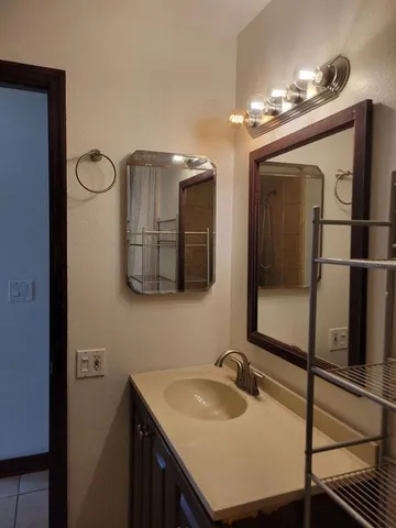a bathroom with a sink vanity and mirror