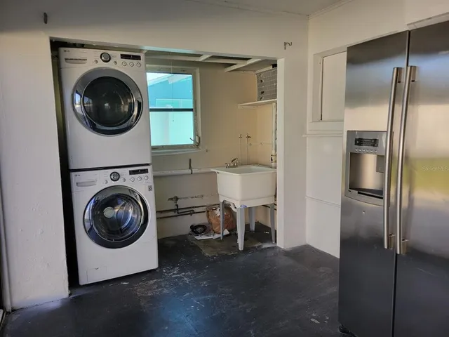 a utility room with sink dryer and washer