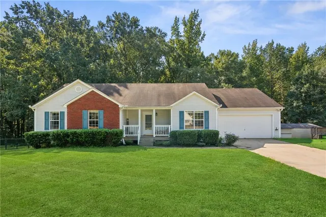 a front view of house with yard and green space