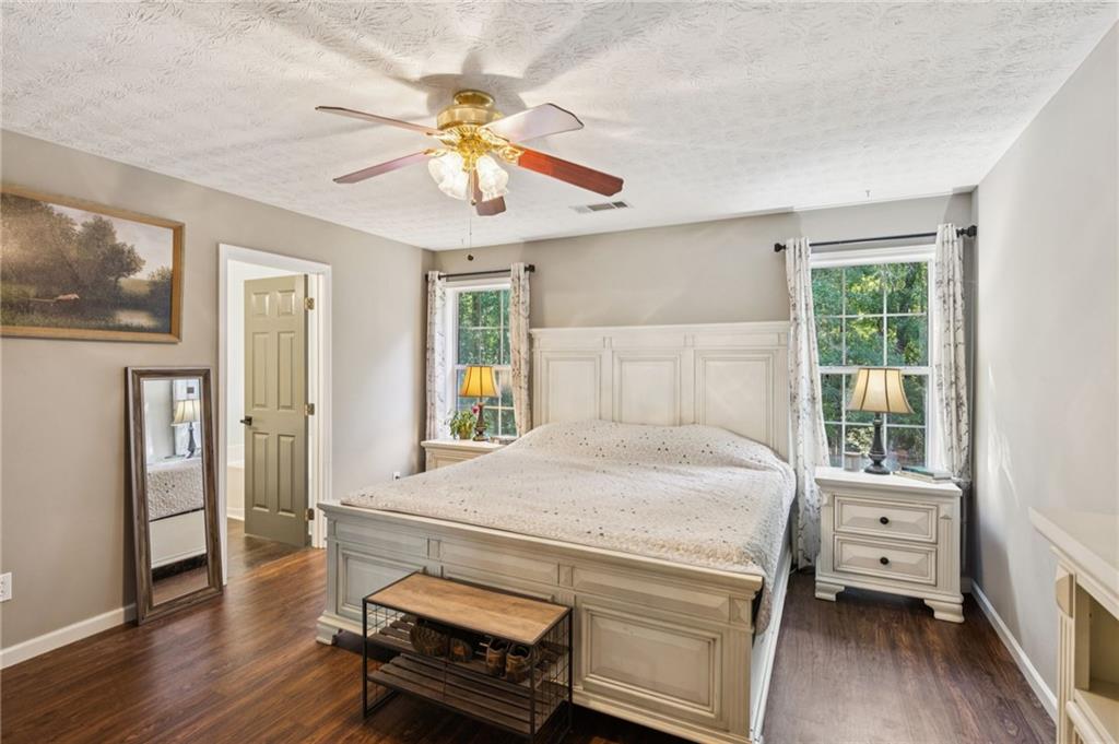 115 Alcovy Circle Covington, GA 30014 - Photo 14 of 27 a bedroom with a bed and wooden floor