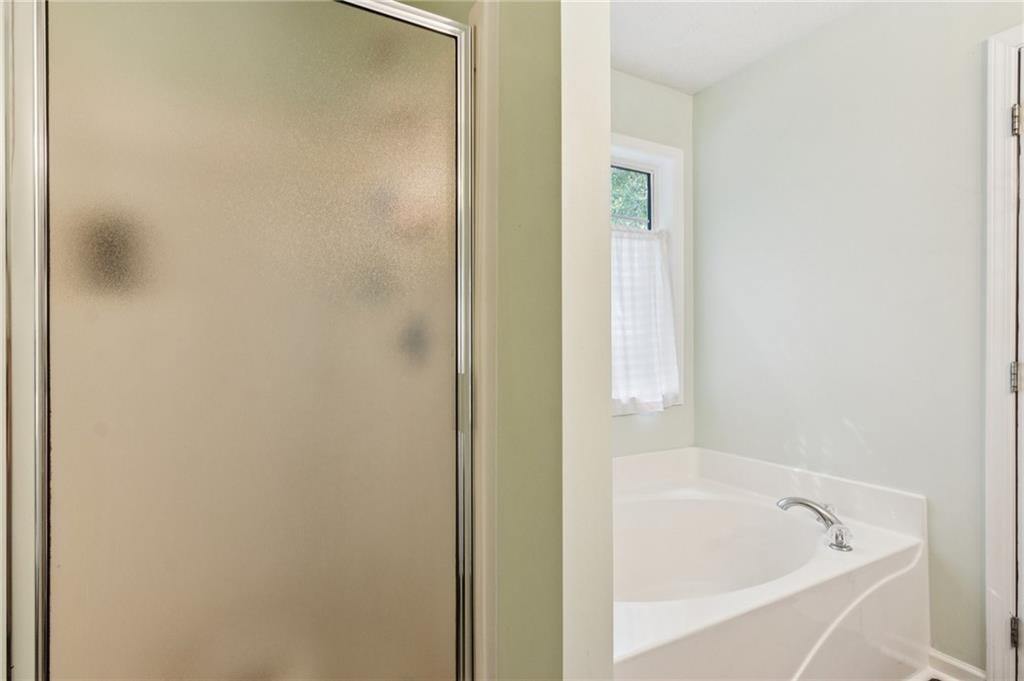 115 Alcovy Circle Covington, GA 30014 - Photo 17 of 27 a white bath tub sitting next to a small window