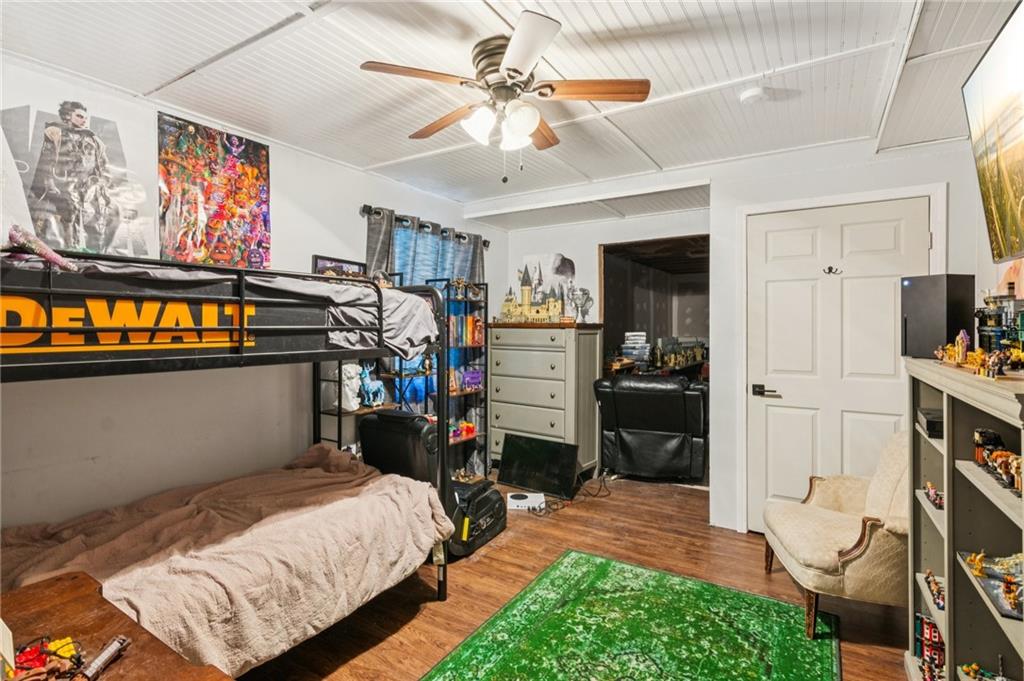 115 Alcovy Circle Covington, GA 30014 - Photo 21 of 27 a bedroom with bed and wooden floor