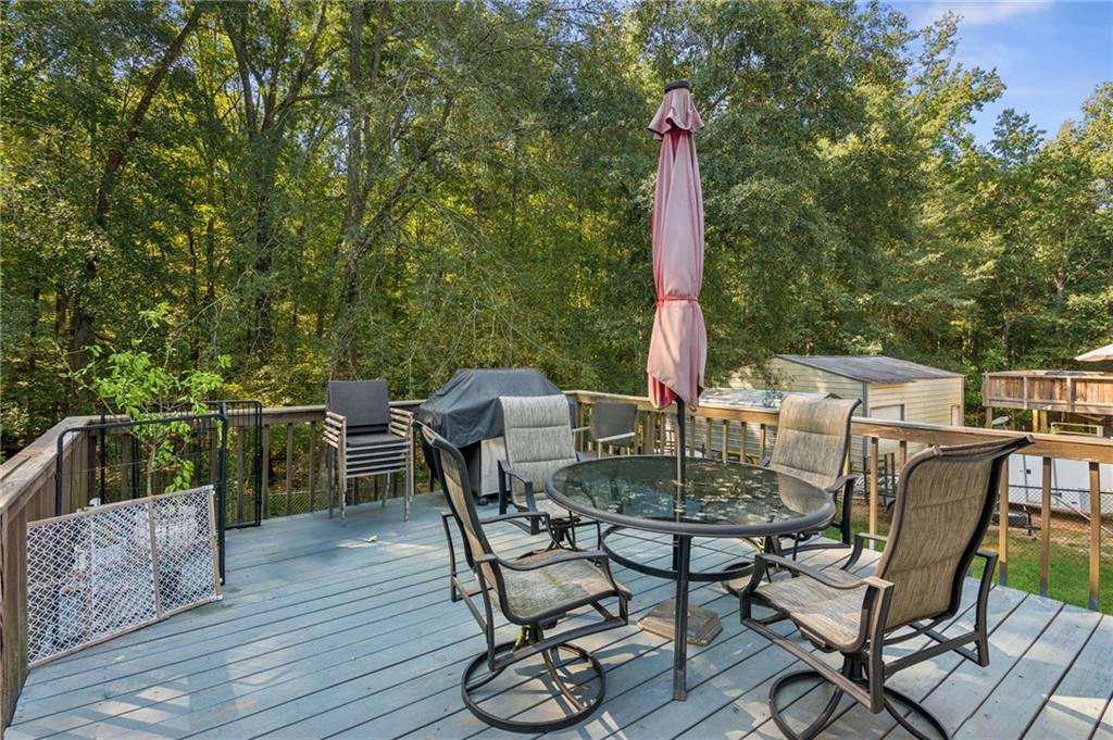 115 Alcovy Circle Covington, GA 30014 - Photo 22 of 27 a view of a table and chairs on the roof deck
