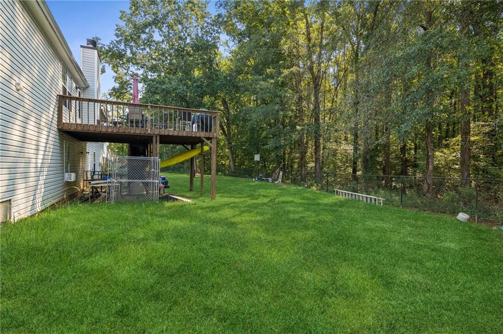 115 Alcovy Circle Covington, GA 30014 - Photo 23 of 27 a view of a deck with a table and chairs