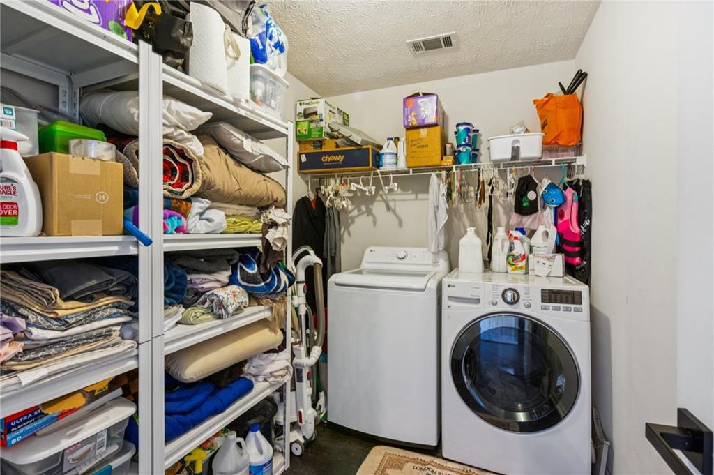 115 Alcovy Circle Covington, GA 30014 - Photo 26 of 27 a utility room with dryer and washer