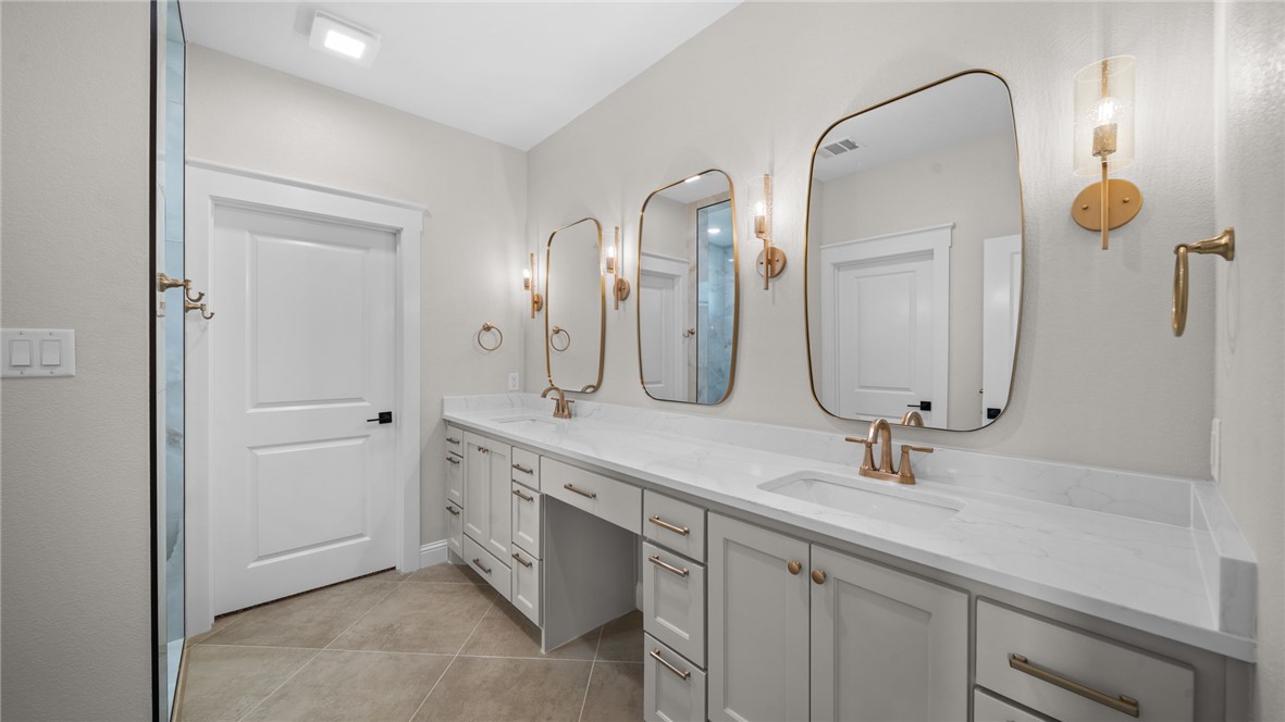 162 Buffalo Rdg Road Giddings, TX 78942 - Photo 13 of 31 a bathroom with a double vanity sink and a mirror
