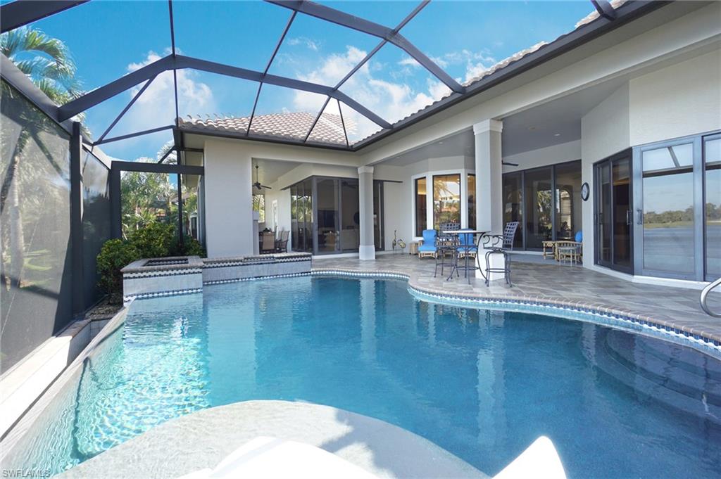 7316 Hagen Way Naples, FL 34113 - Photo 11 of 48 a view of a swimming pool with an outdoor seating