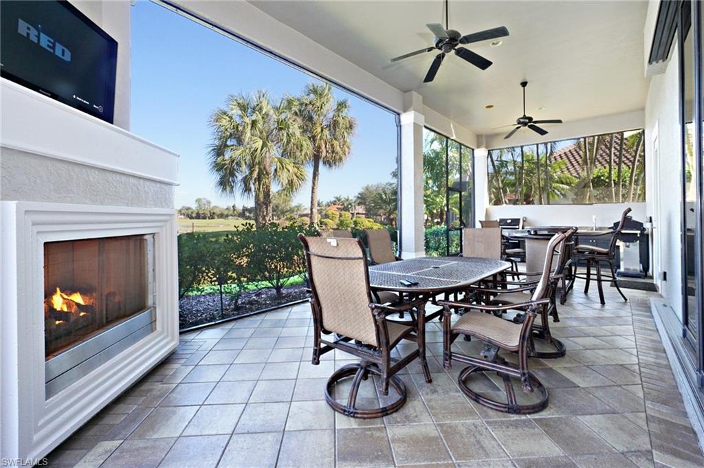 7316 Hagen Way Naples, FL 34113 - Photo 16 of 48 a view of a patio with a table and chairs