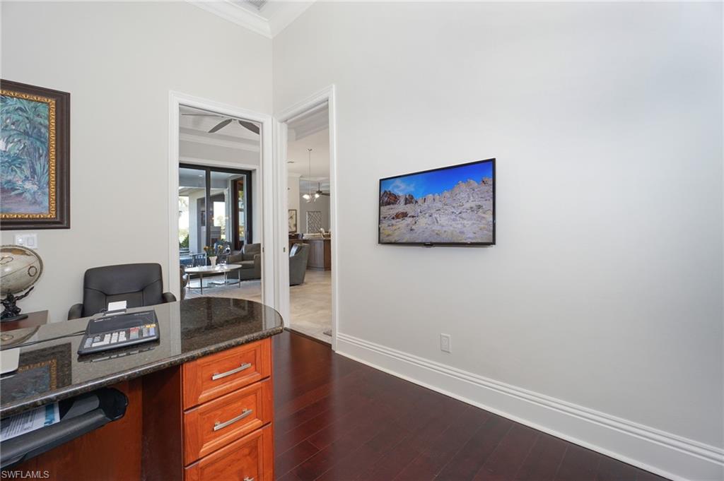 7316 Hagen Way Naples, FL 34113 - Photo 21 of 48 a workspace with furniture and painting on the wall