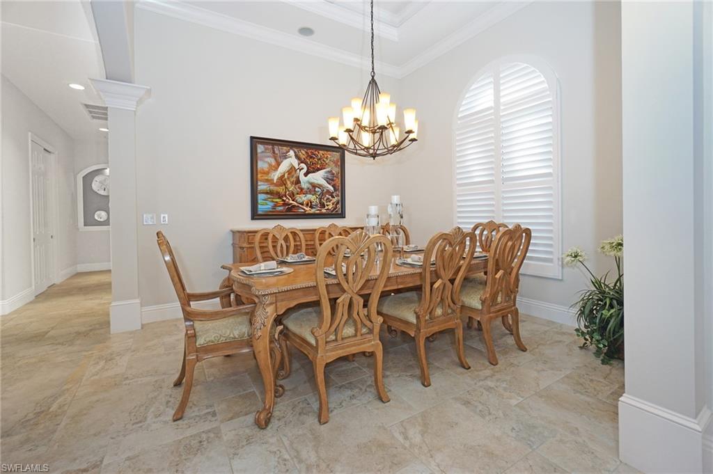 7316 Hagen Way Naples, FL 34113 - Photo 22 of 48 a view of a dining room with furniture and a chandelier