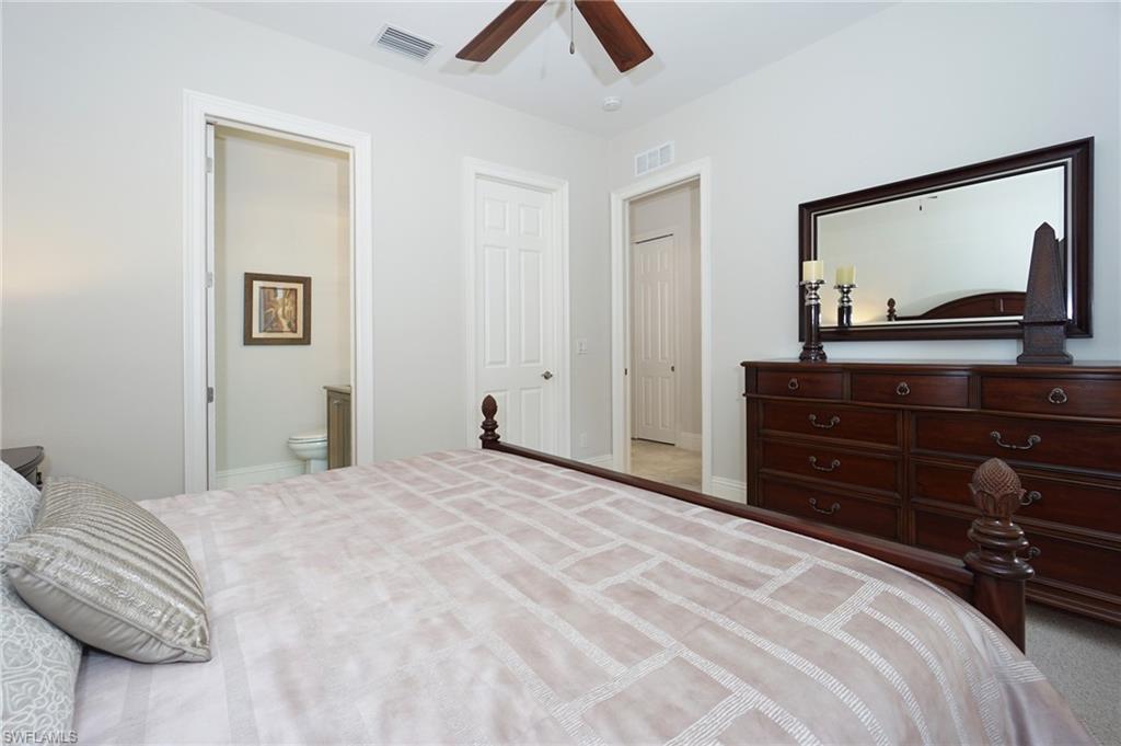 7316 Hagen Way Naples, FL 34113 - Photo 39 of 48 a bedroom with a bed and a flat tv screen on dresser