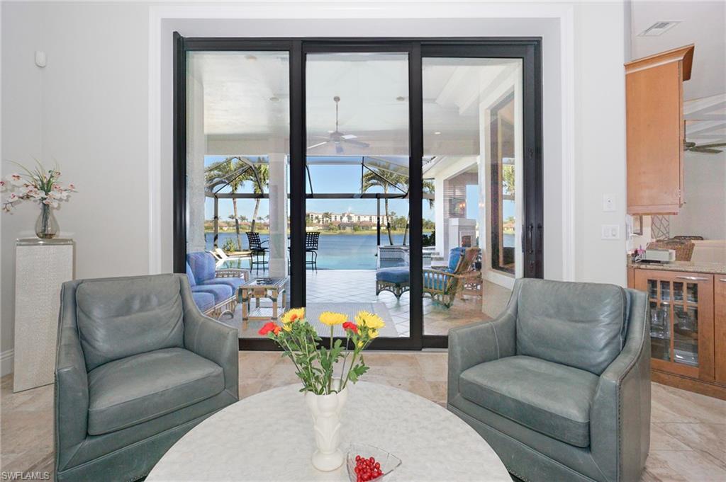 7316 Hagen Way Naples, FL 34113 - Photo 7 of 48 a living room with furniture and a large window