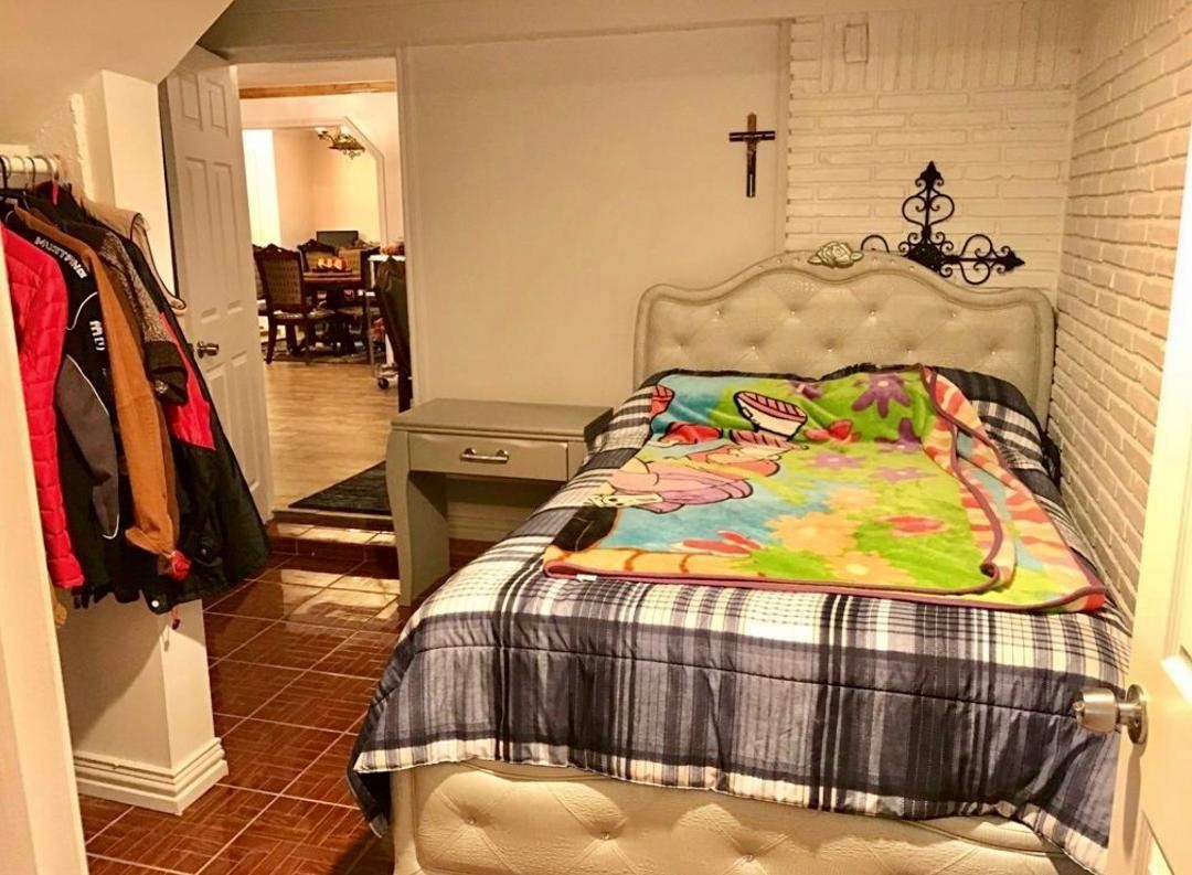 2230 Gault Road Houston, TX 77039 - Photo 11 of 30 a bedroom with a bed a couch and wooden floor