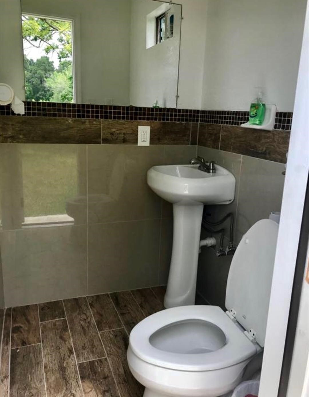 2230 Gault Road Houston, TX 77039 - Photo 14 of 30 a bathroom with a toilet a sink and mirror