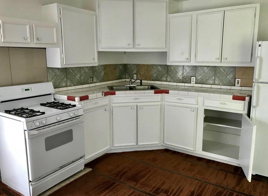 2230 Gault Road Houston, TX 77039 - Photo 26 of 30 a kitchen with cabinets appliances and a sink