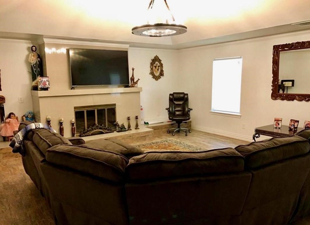 2230 Gault Road Houston, TX 77039 - Photo 27 of 30 a living room with fireplace furniture and a flat screen tv