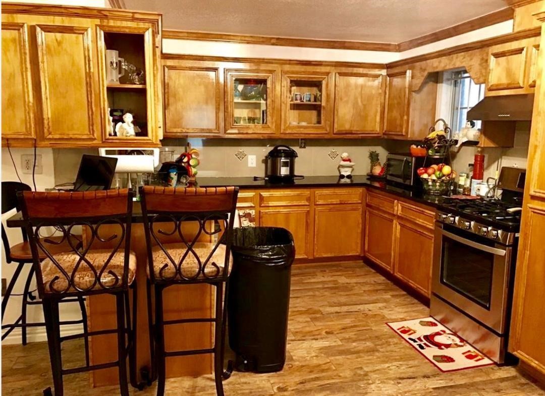 2230 Gault Road Houston, TX 77039 - Photo 8 of 30 a kitchen with stainless steel appliances granite countertop a stove top oven microwave and cabinets