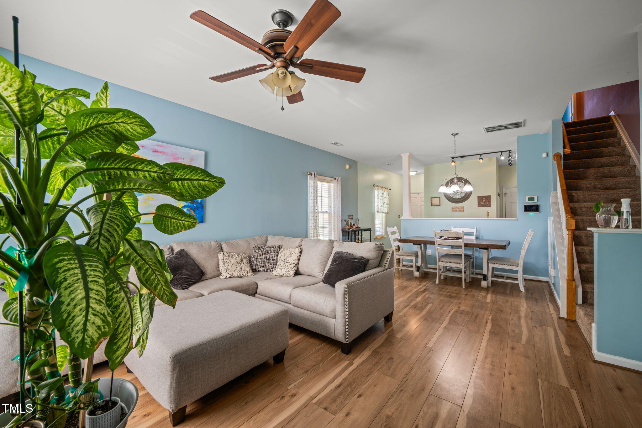 2105 Metacomet Way Raleigh, NC 27604 - Photo 12 of 43 a living room with furniture a potted plant and a large window