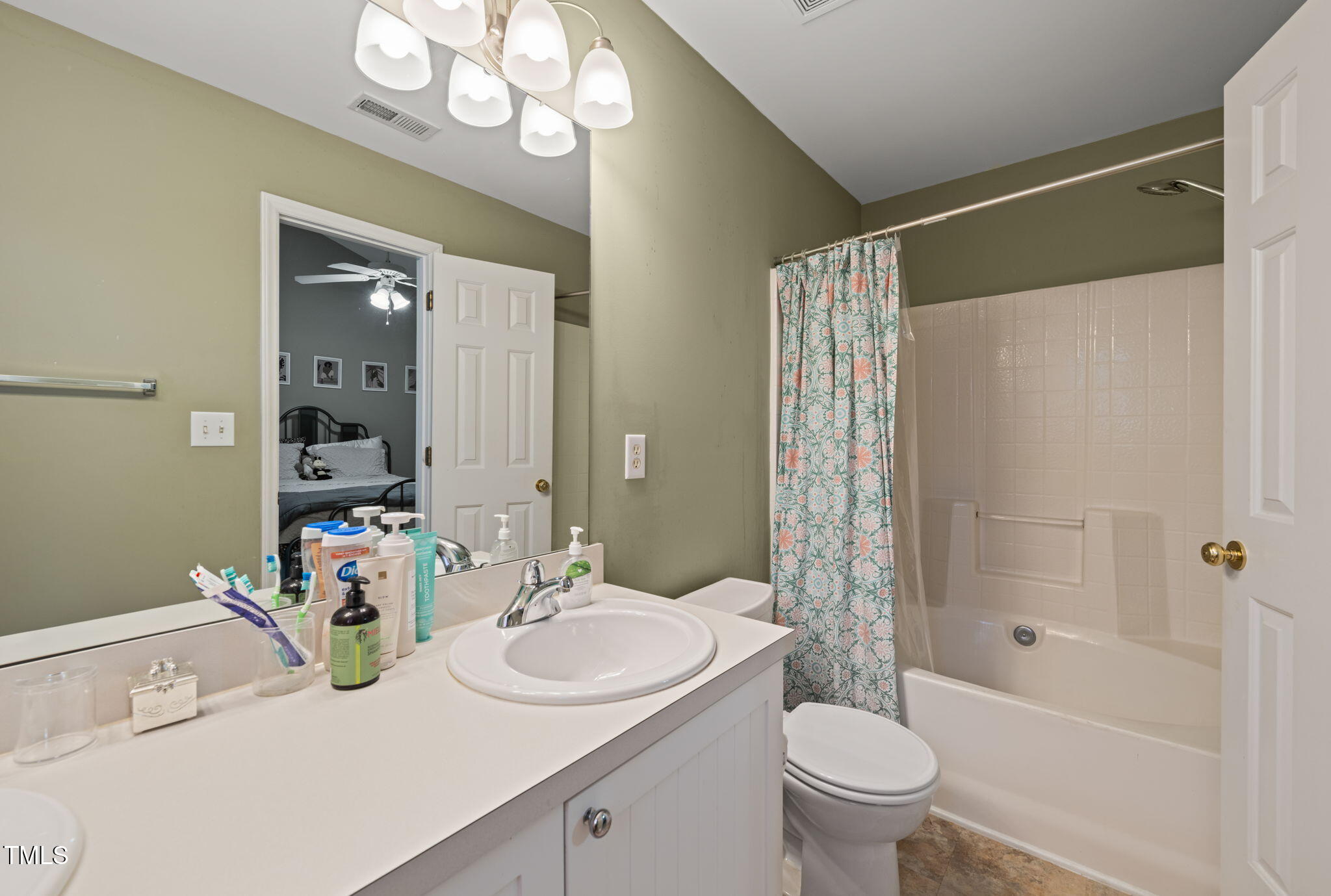 2105 Metacomet Way Raleigh, NC 27604 - Photo 18 of 43 a bathroom with a sink a toilet and shower