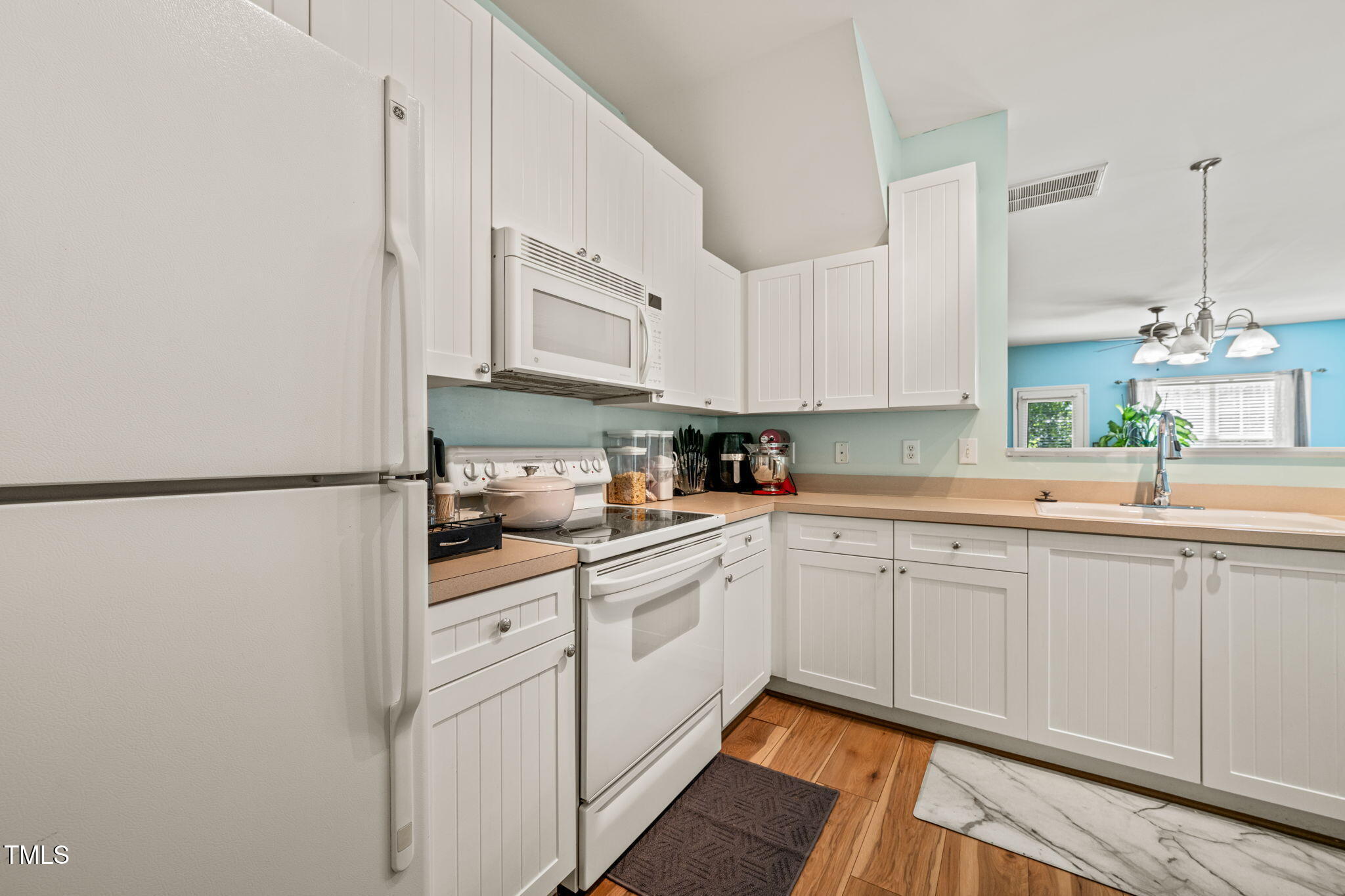 2105 Metacomet Way Raleigh, NC 27604 - Photo 4 of 43 a kitchen with white cabinets and white appliances