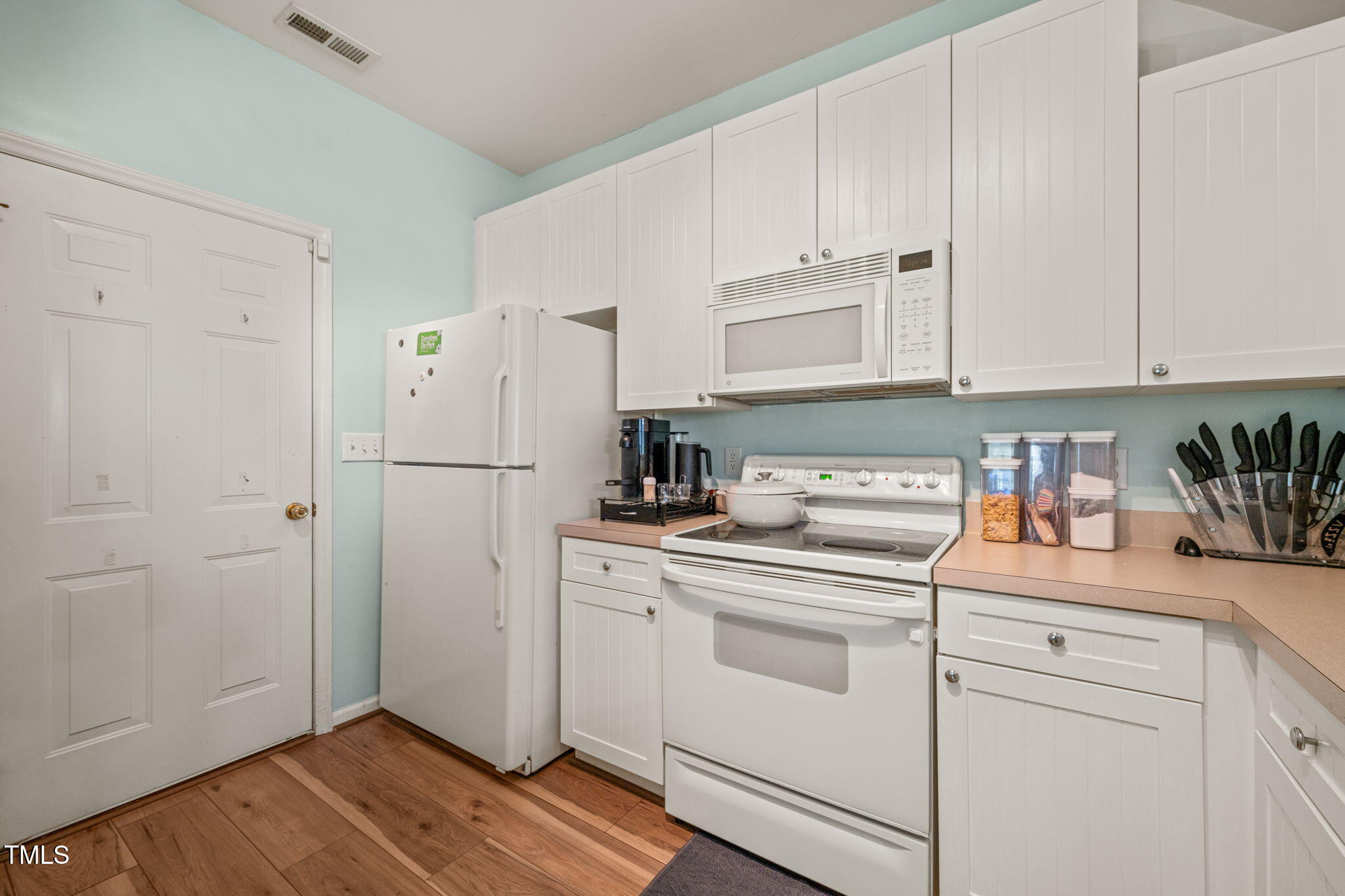 2105 Metacomet Way Raleigh, NC 27604 - Photo 5 of 43 a kitchen with white cabinets and white appliances