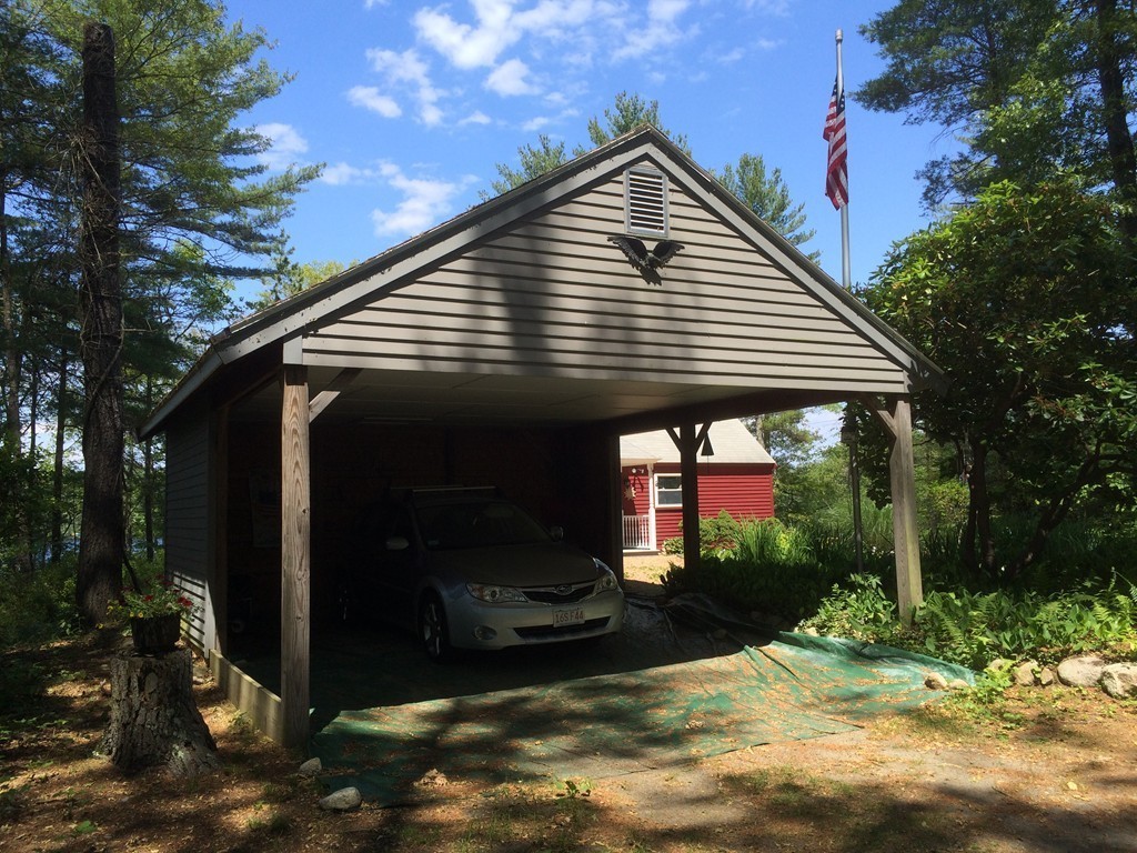 80 Snows Pond Road Rochester, MA 02770 - Photo 3 of 11 a front view of a house with garden