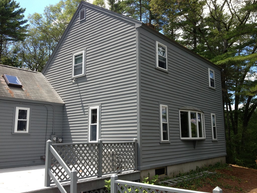80 Snows Pond Road Rochester, MA 02770 - Photo 8 of 11 a side view of a house with a yard and furniture