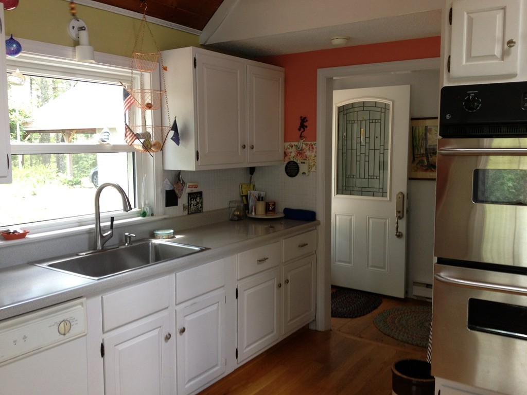 80 Snows Pond Road Rochester, MA 02770 - Photo 9 of 11 a kitchen with a sink cabinets stainless steel appliances and a window